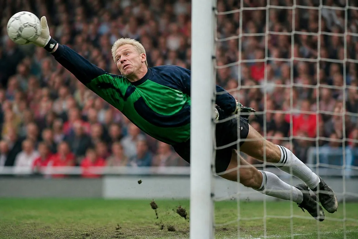 Peter Schmeichel making a crucial save during a 1990s match