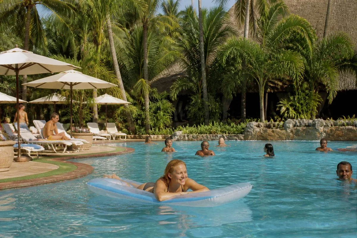 Guests enjoying the outdoor pool at Paradise Park Hotel