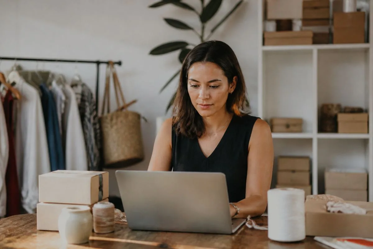 A small business owner setting up an online store on a laptop