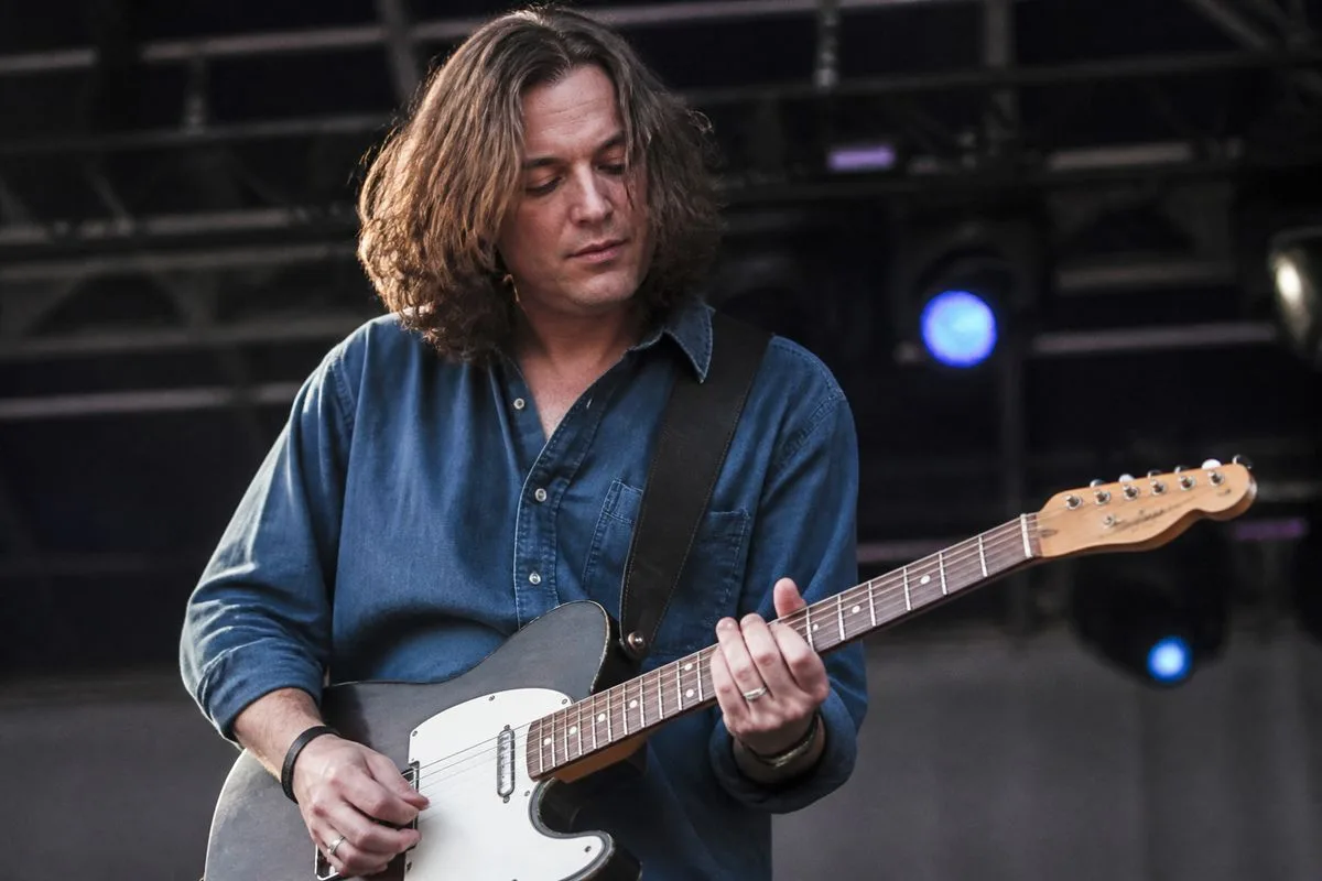 David Surkamp performing live on stage with guitar