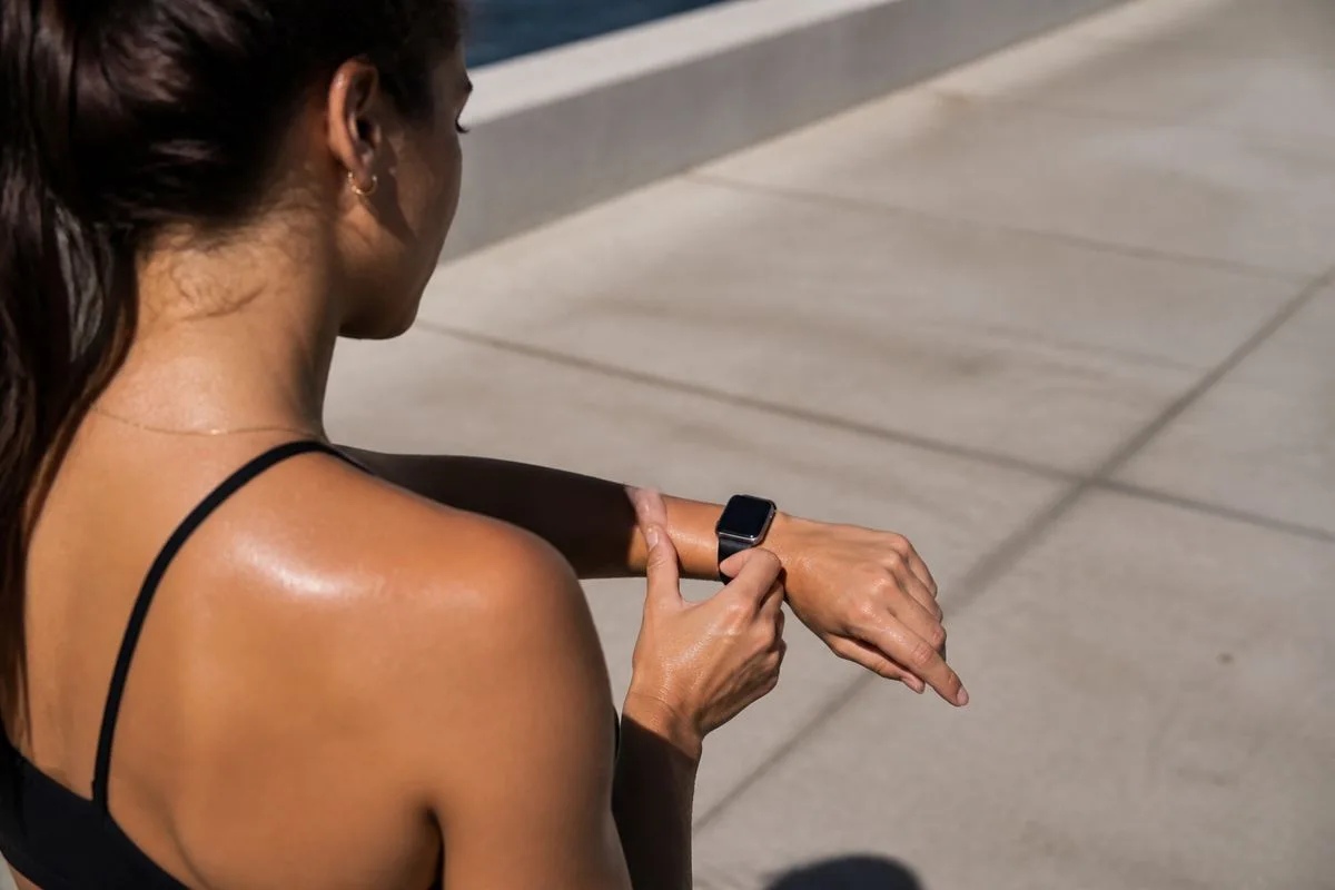 A person checking fitness stats on an Apple Watch during a workout