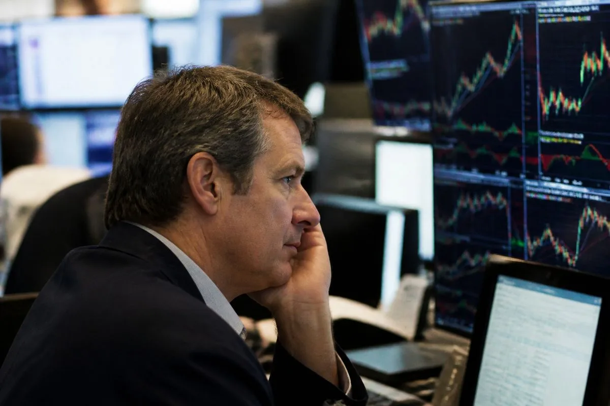 A trader intently watching multiple stock market screens.