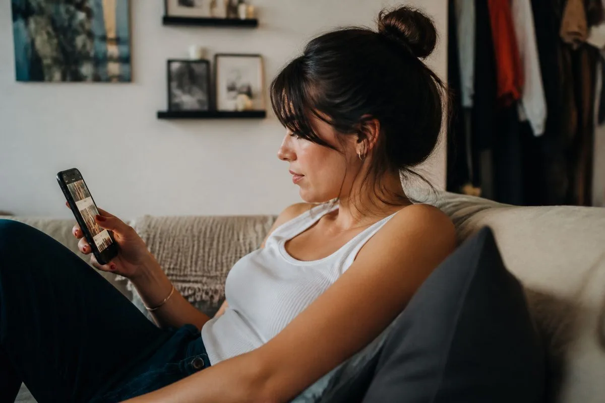 A person scrolling through entertainment news on a smartphone