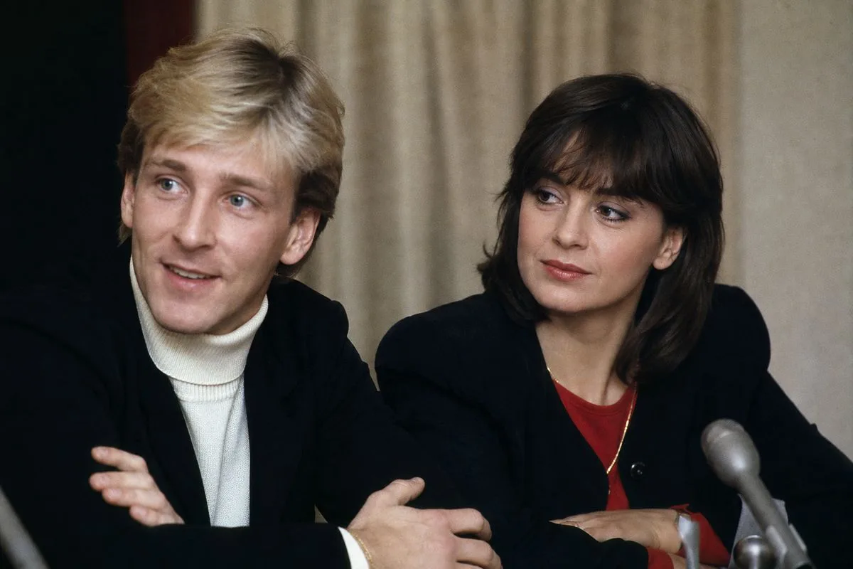 Christopher Dean and Karen Barber seated together at a press event