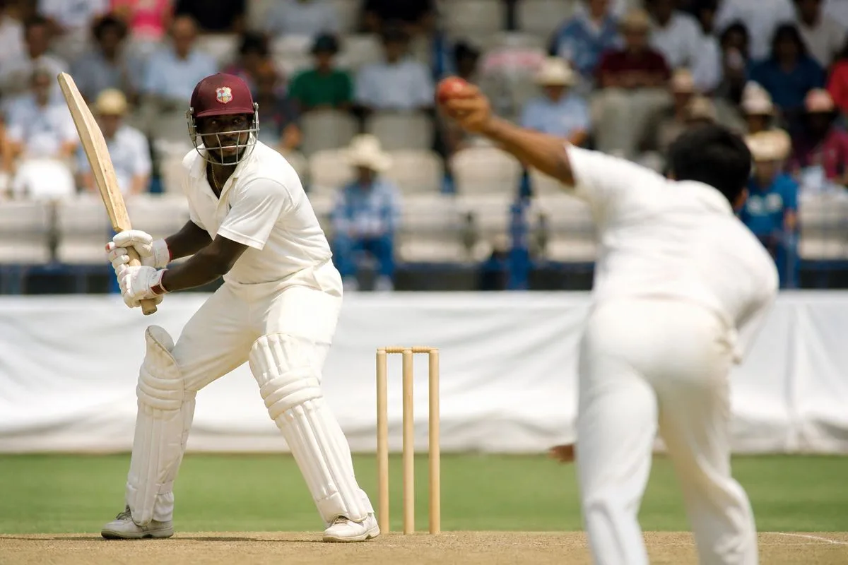 West Indies batsman facing Indian spinner on a sunny day.