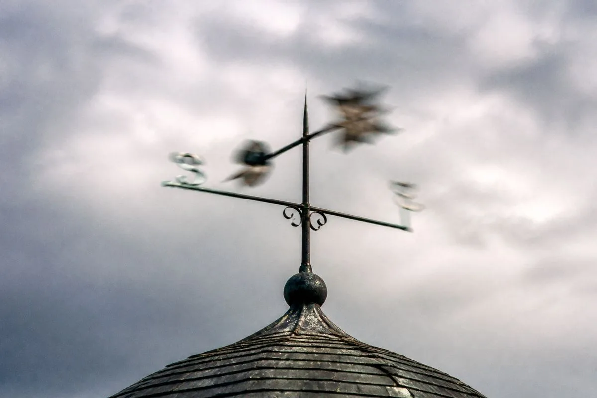 A weather vane spinning rapidly on a windy day