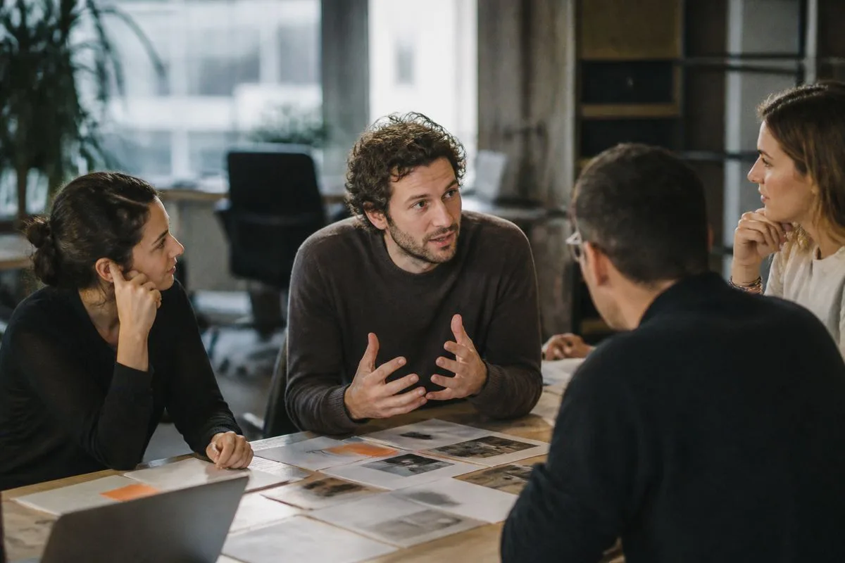 An entrepreneur discussing ideas with a small team in a startup office