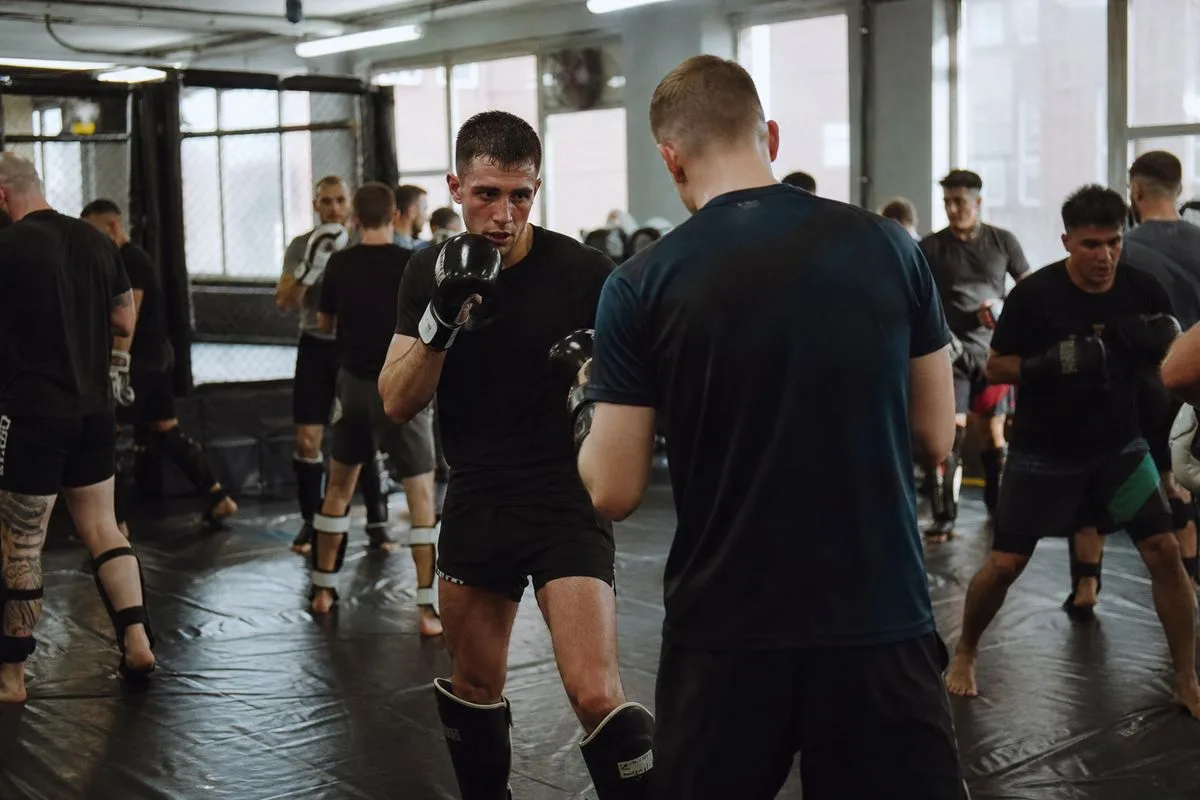 Beginners training in a crowded MMA gym in Manchester