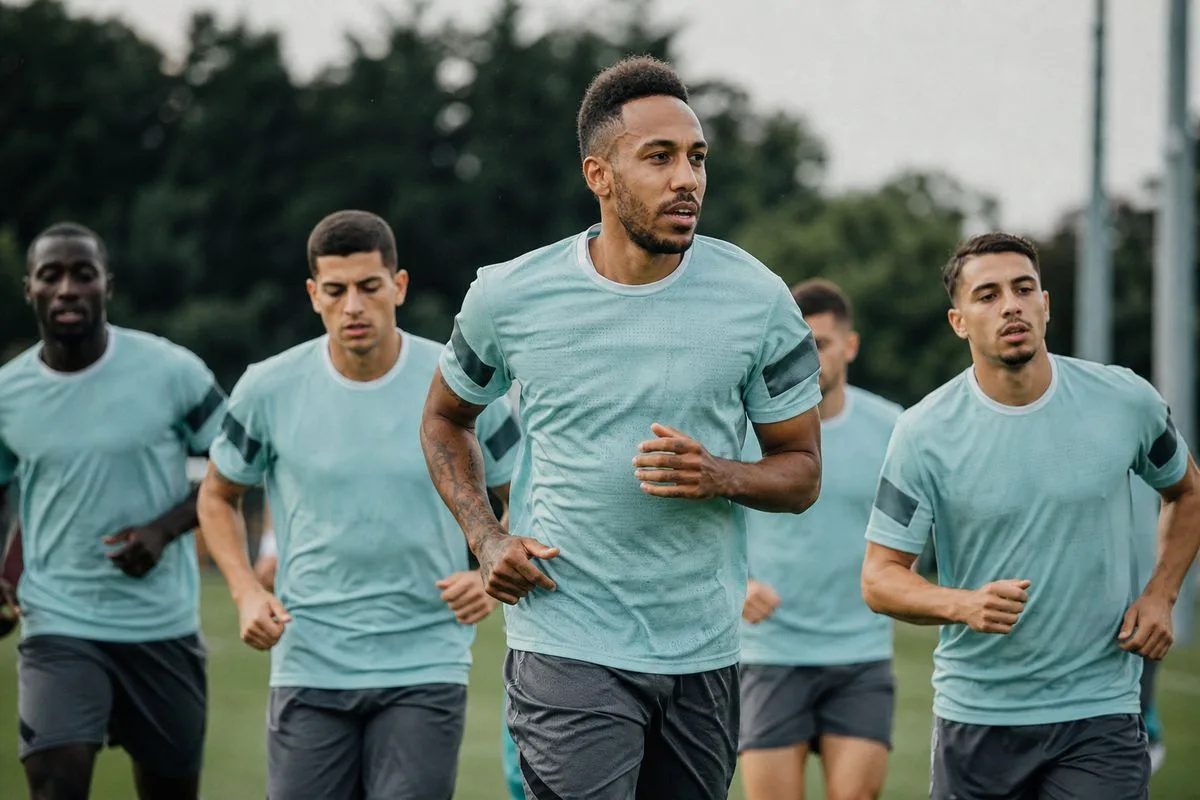Pierre-Emerick Aubameyang leading teammates on the pitch during training