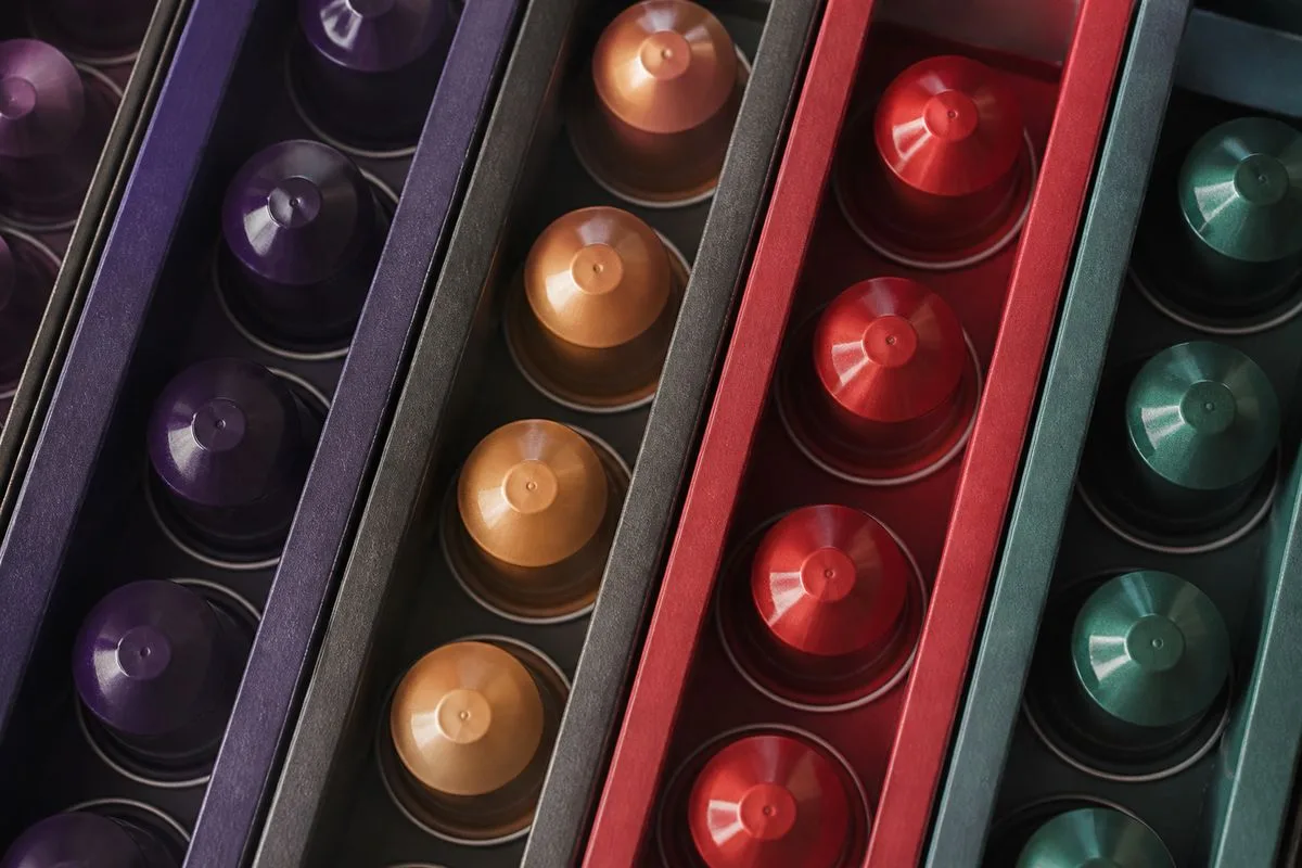 Close-up of coffee capsules arranged in colorful sleeves