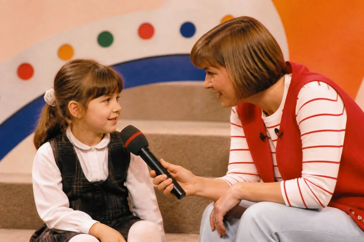 A children’s TV presenter interviewing a young guest on set