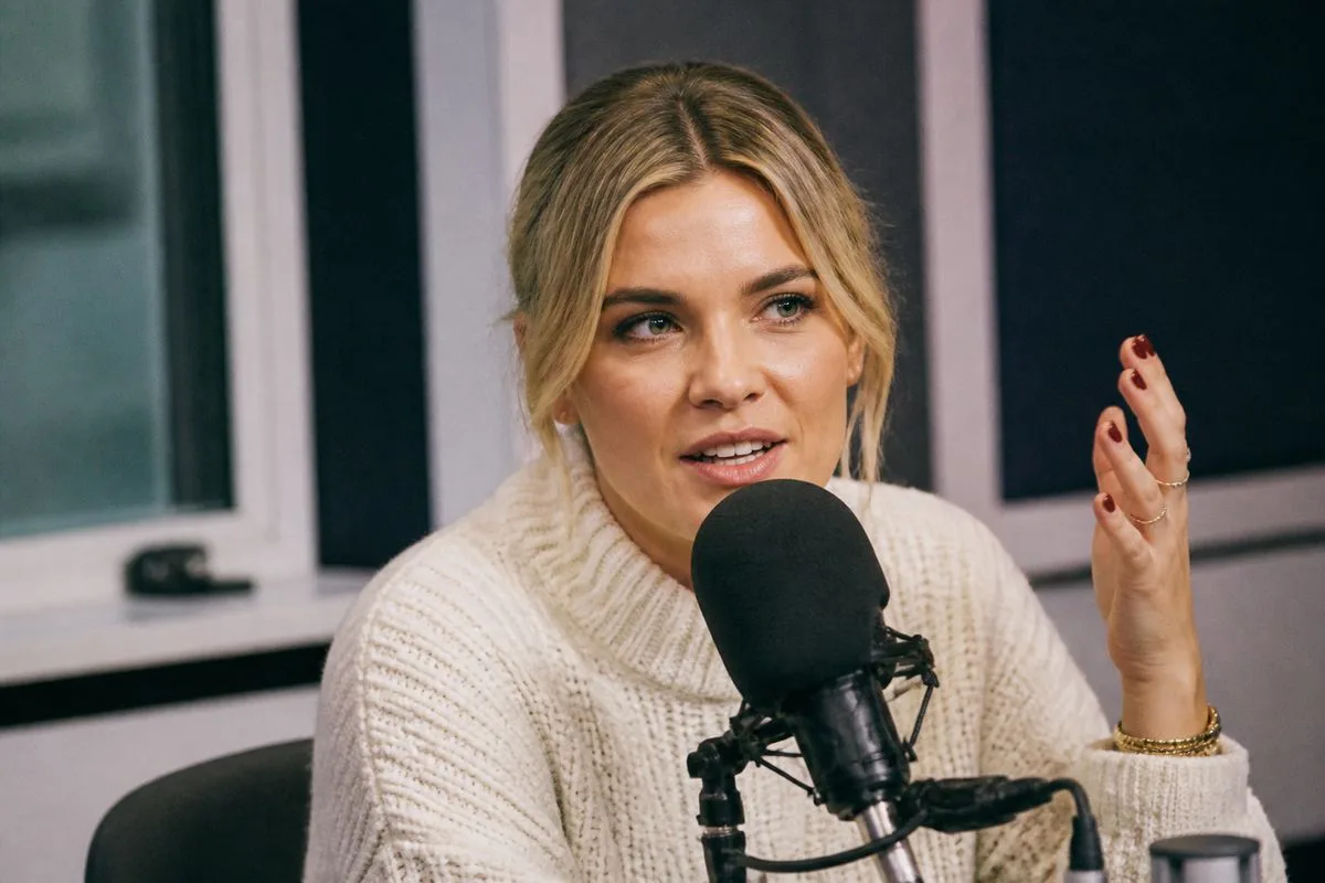 Ashley James speaking candidly on a radio show microphone