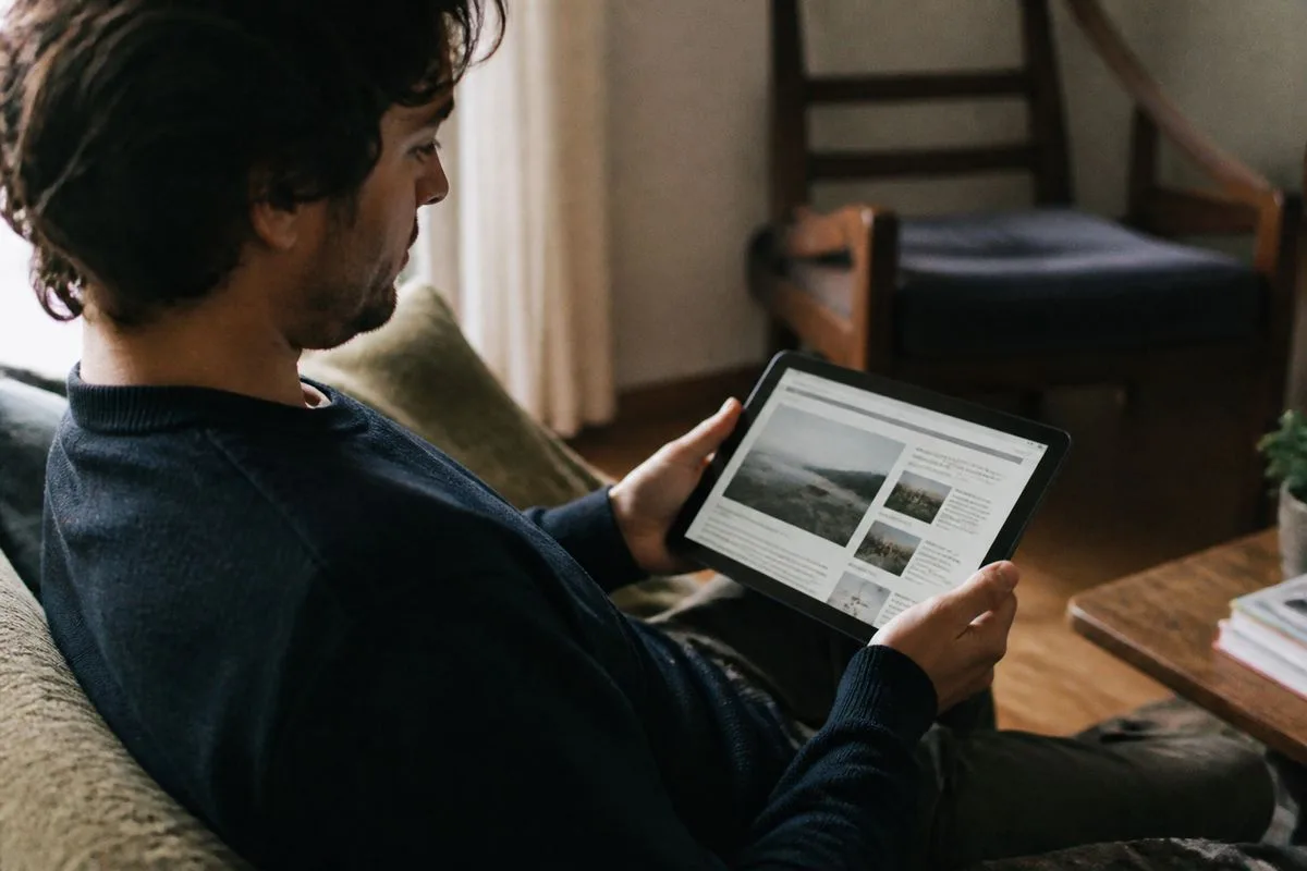 A reader browsing an online news article on a tablet