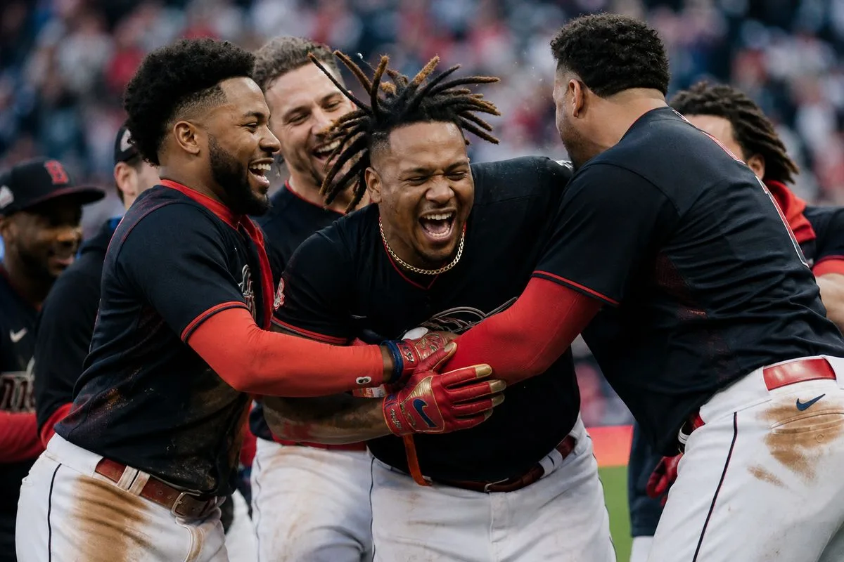 Cleveland Guardians players celebrating on the field after a win