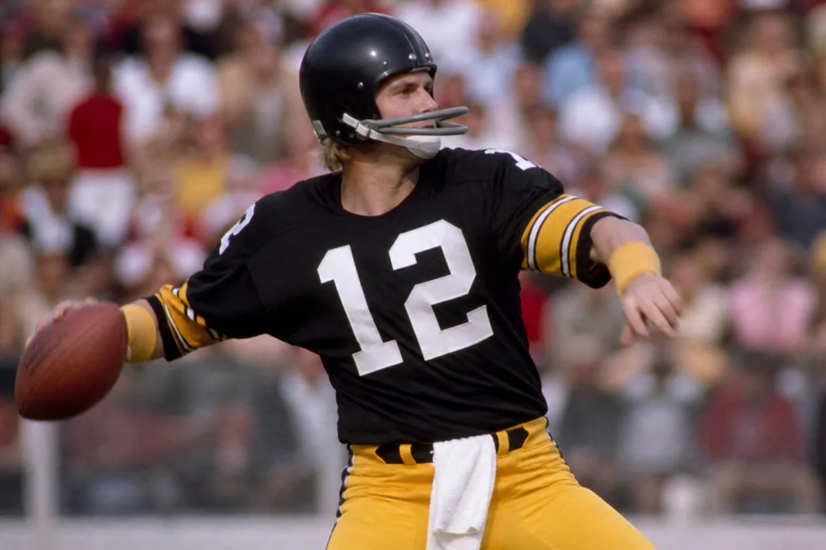Terry Bradshaw in Steelers uniform throwing a pass game-time