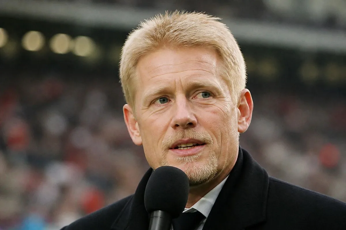 Peter Schmeichel speaking into a microphone at a sports event