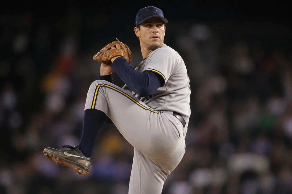 Brewers pitcher winds up during a tense late-inning game.