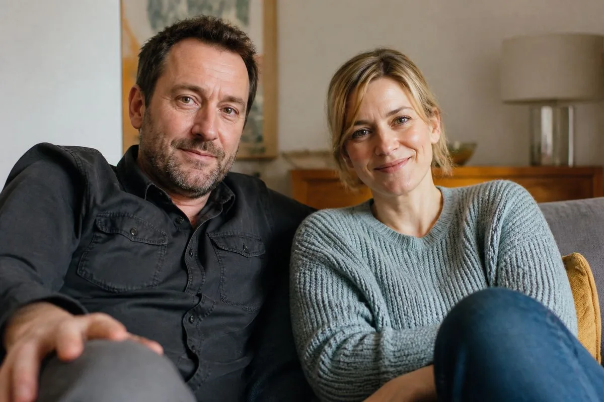 Lee Mack and Sally Bretton sitting in a cozy living room.