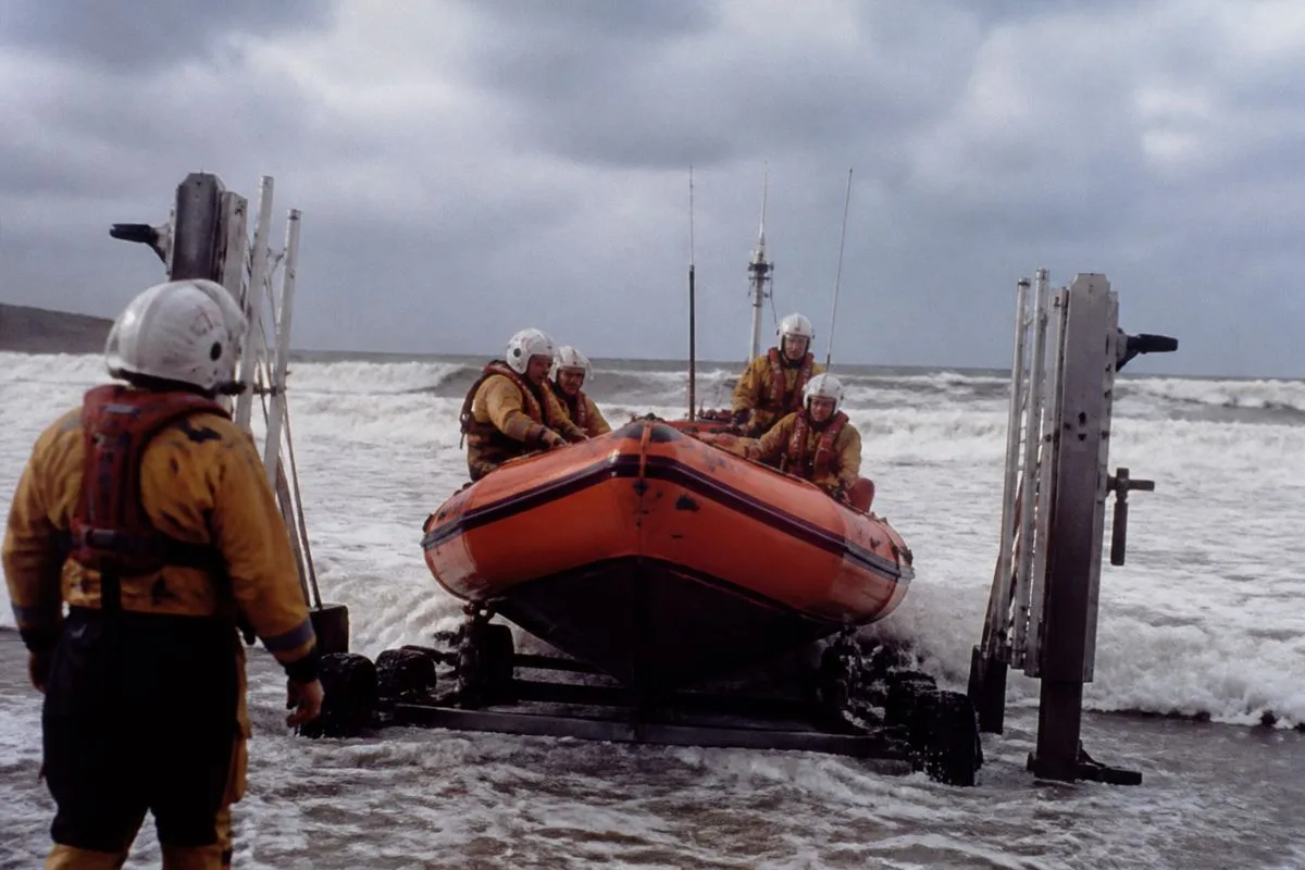 RNLI volunteers launching a lifeboat in rough seas
