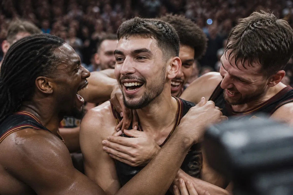 Ty Jerome celebrating with teammates after a game-winning shot