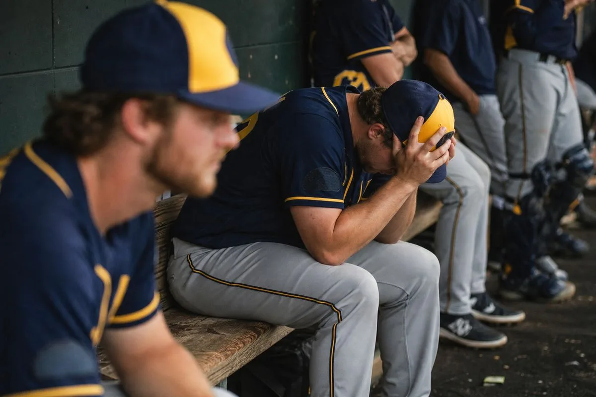 Milwaukee Brewers players reacting after a close game loss