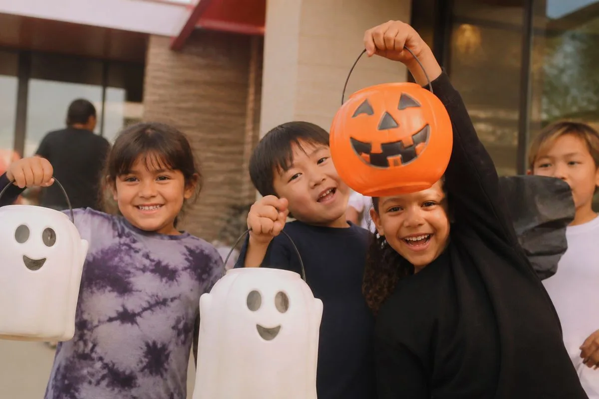 Children eagerly holding McDonald’s Boo Buckets outside a restaurant