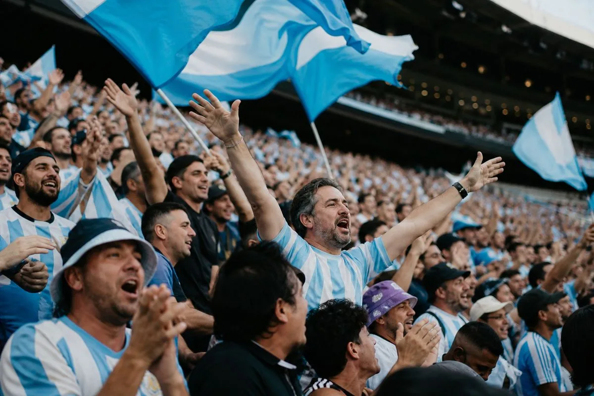 Fans cheering in a packed stadium during a soccer match