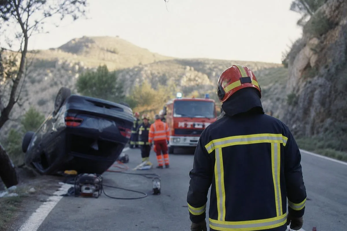 Emergency responders at a roadside crash scene in Spain
