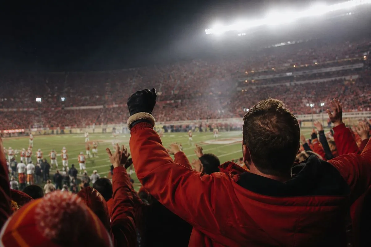 Fans cheering as Kansas City Chiefs play under stadium lights