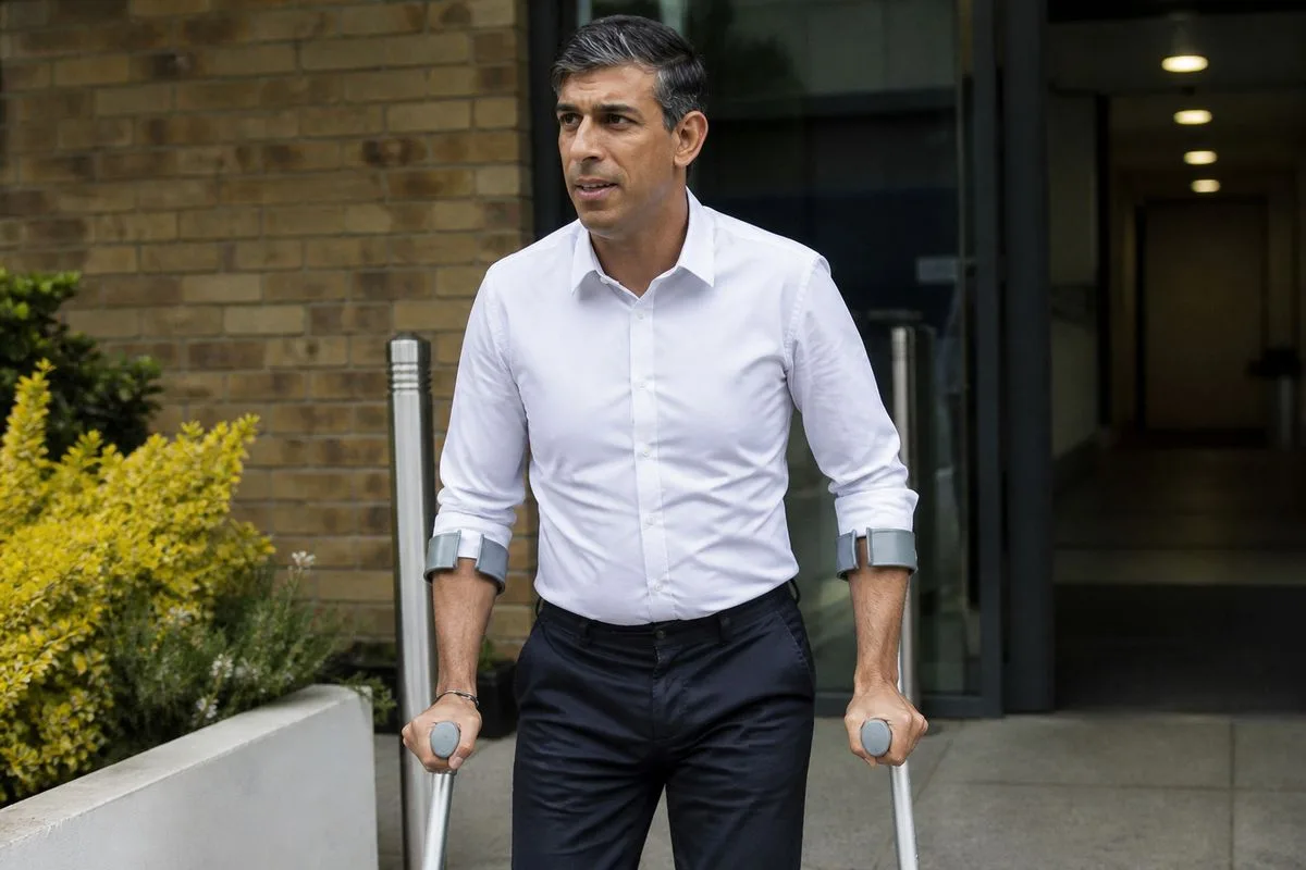 Former Prime Minister Sunak on crutches outside medical center