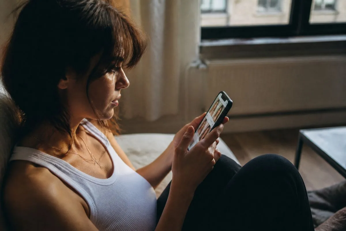 A person scrolling through entertainment news on a smartphone