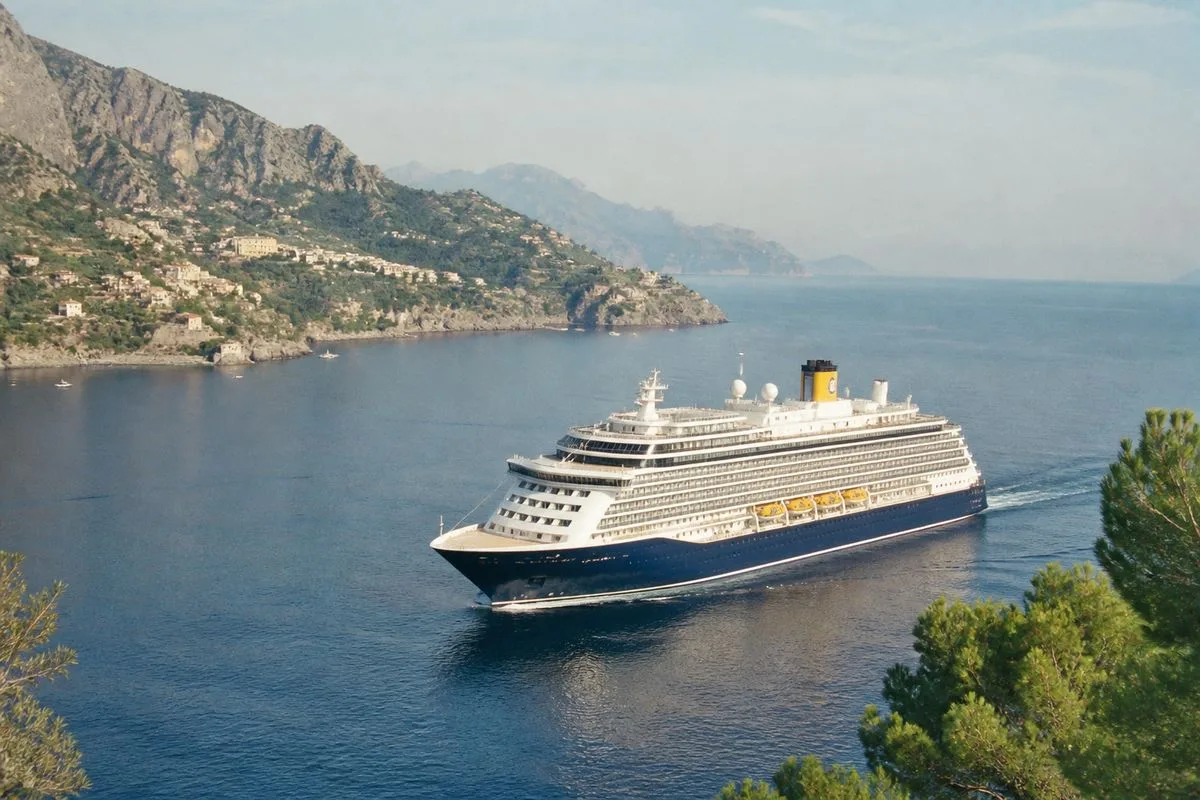 The Saga Spirit of Discovery cruising past a Mediterranean coastline