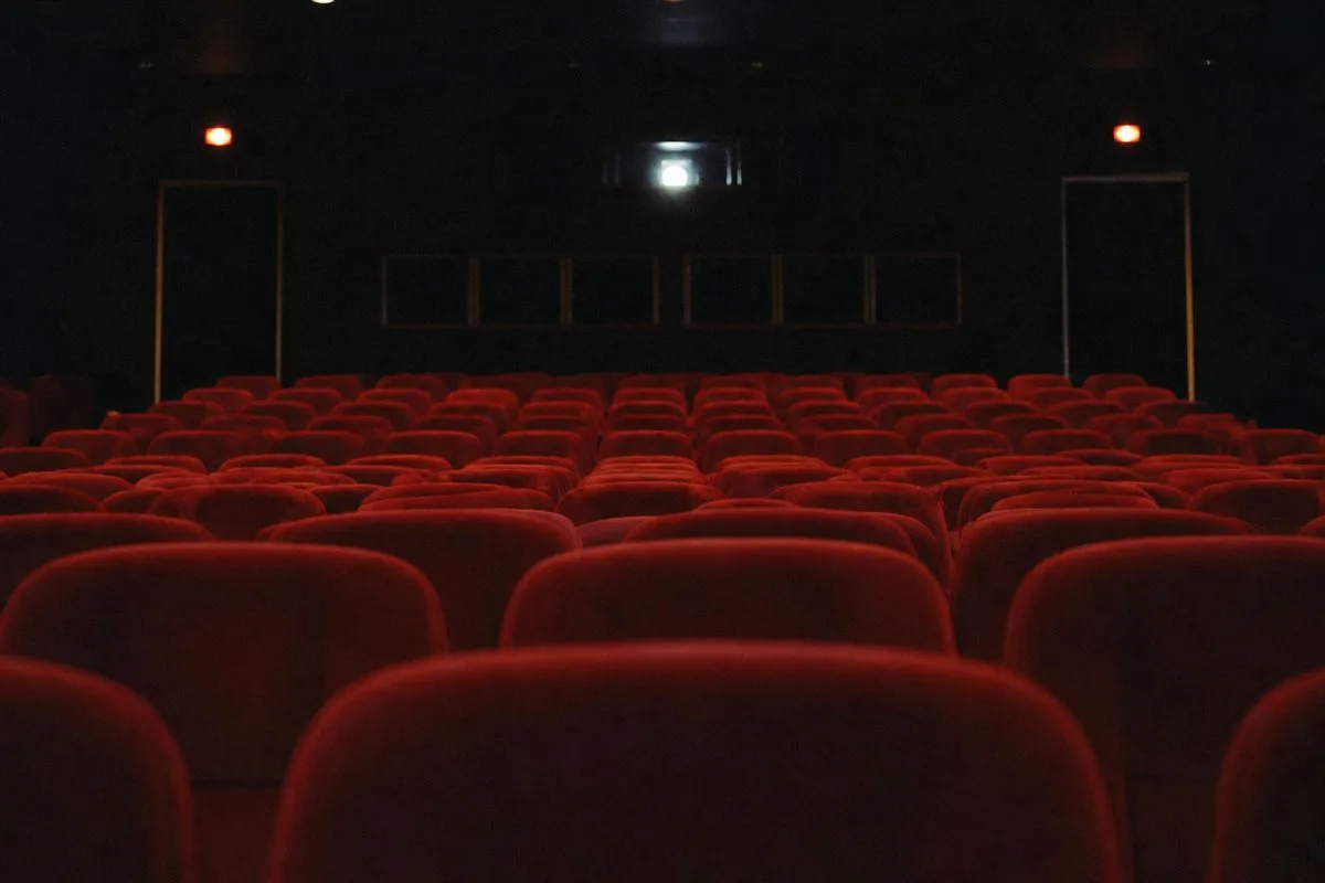 Empty movie theater auditorium with dimmed lights