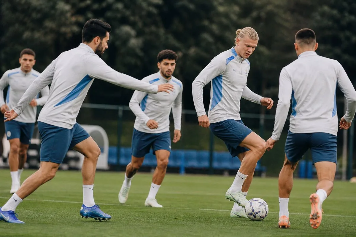Manchester City players training on the pitch during practice
