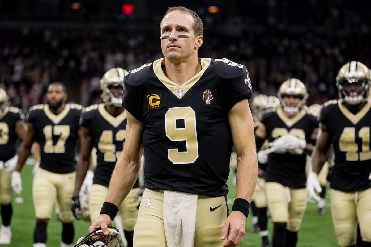 Drew Brees leading the New Orleans Saints on the field.