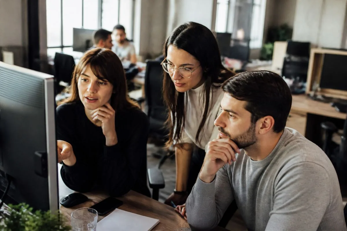 Employees collaborating in a modern tech office space