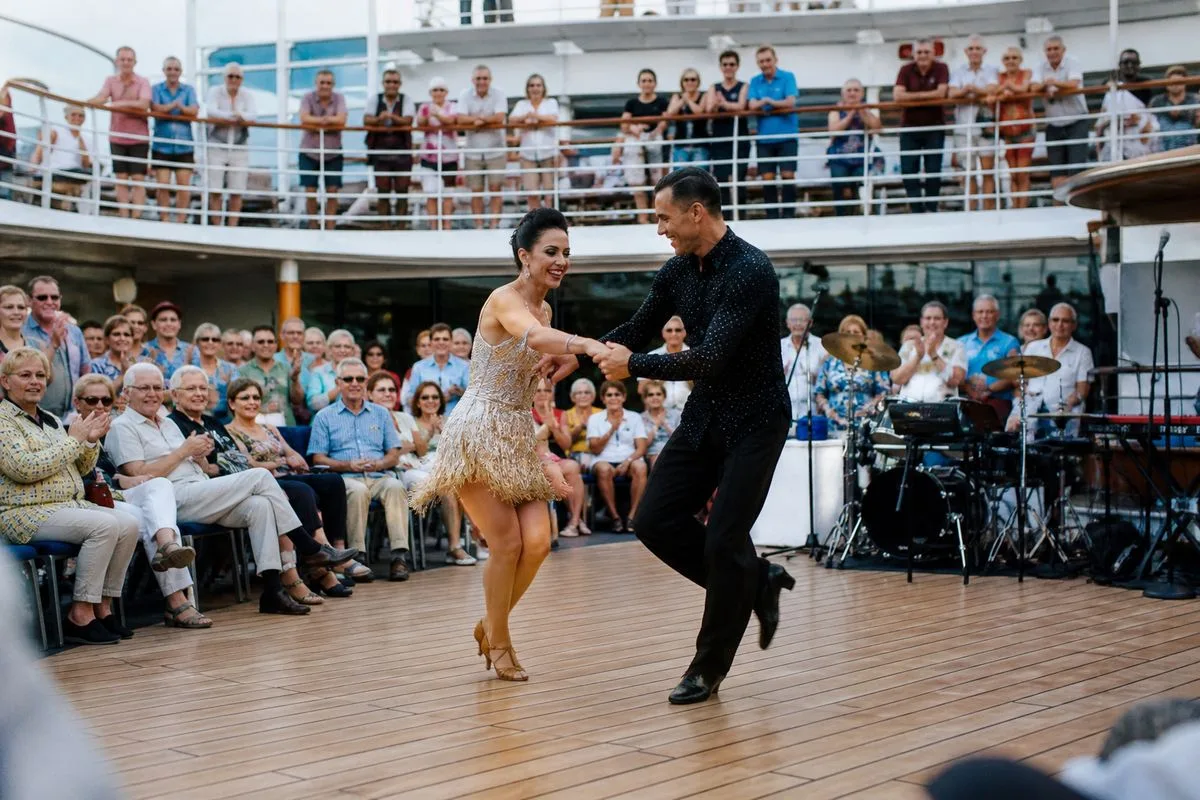 Passengers enjoying a live Strictly dance performance on a cruise ship deck