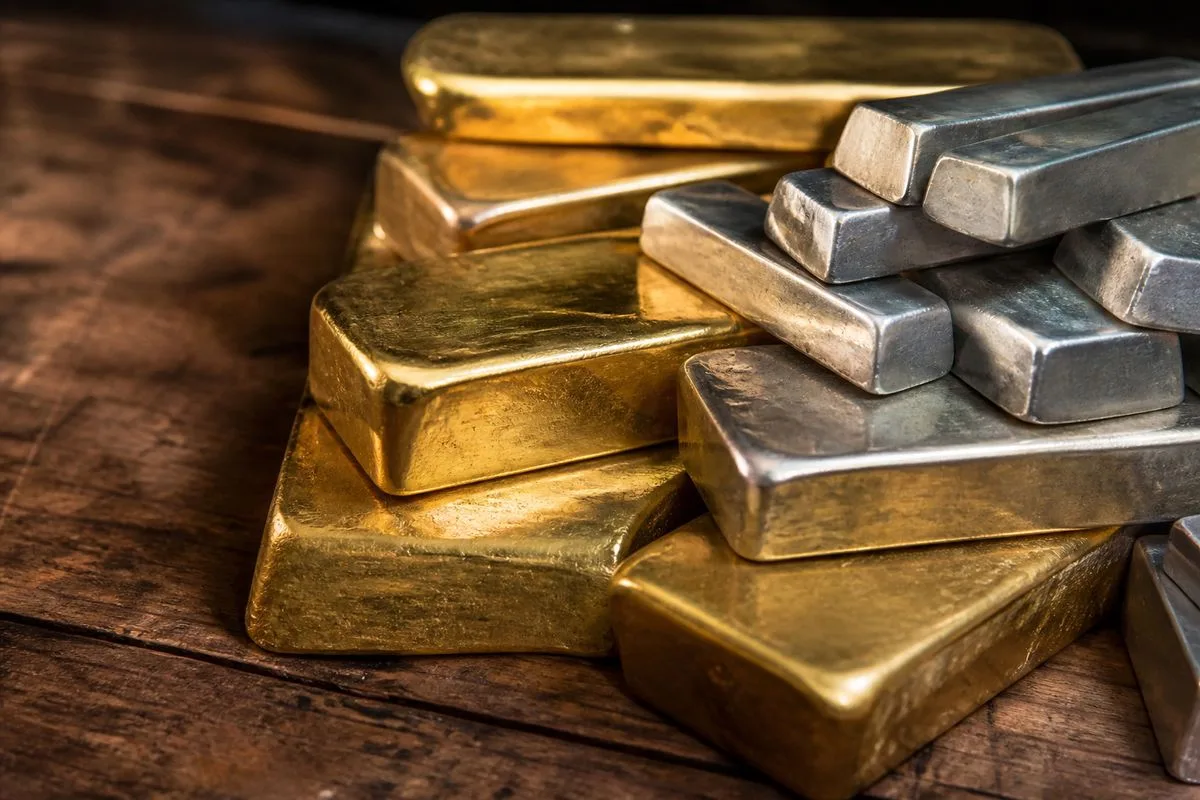 Close-up of gold and silver bars stacked on a wooden table