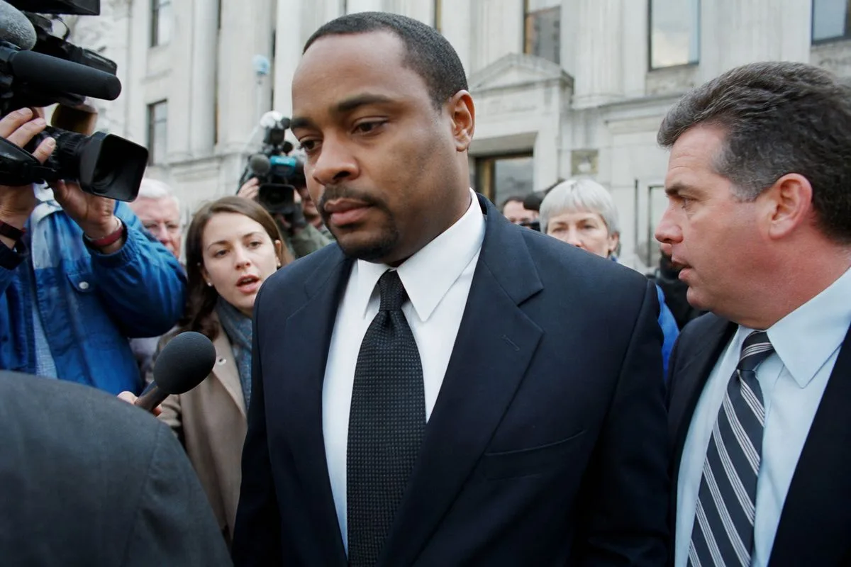 Daniel Thomas leaving a courthouse surrounded by reporters