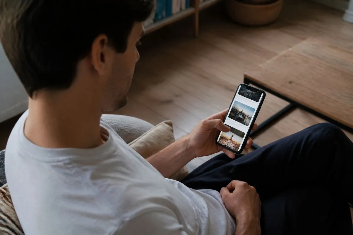 A person scrolling through news articles on a smartphone.