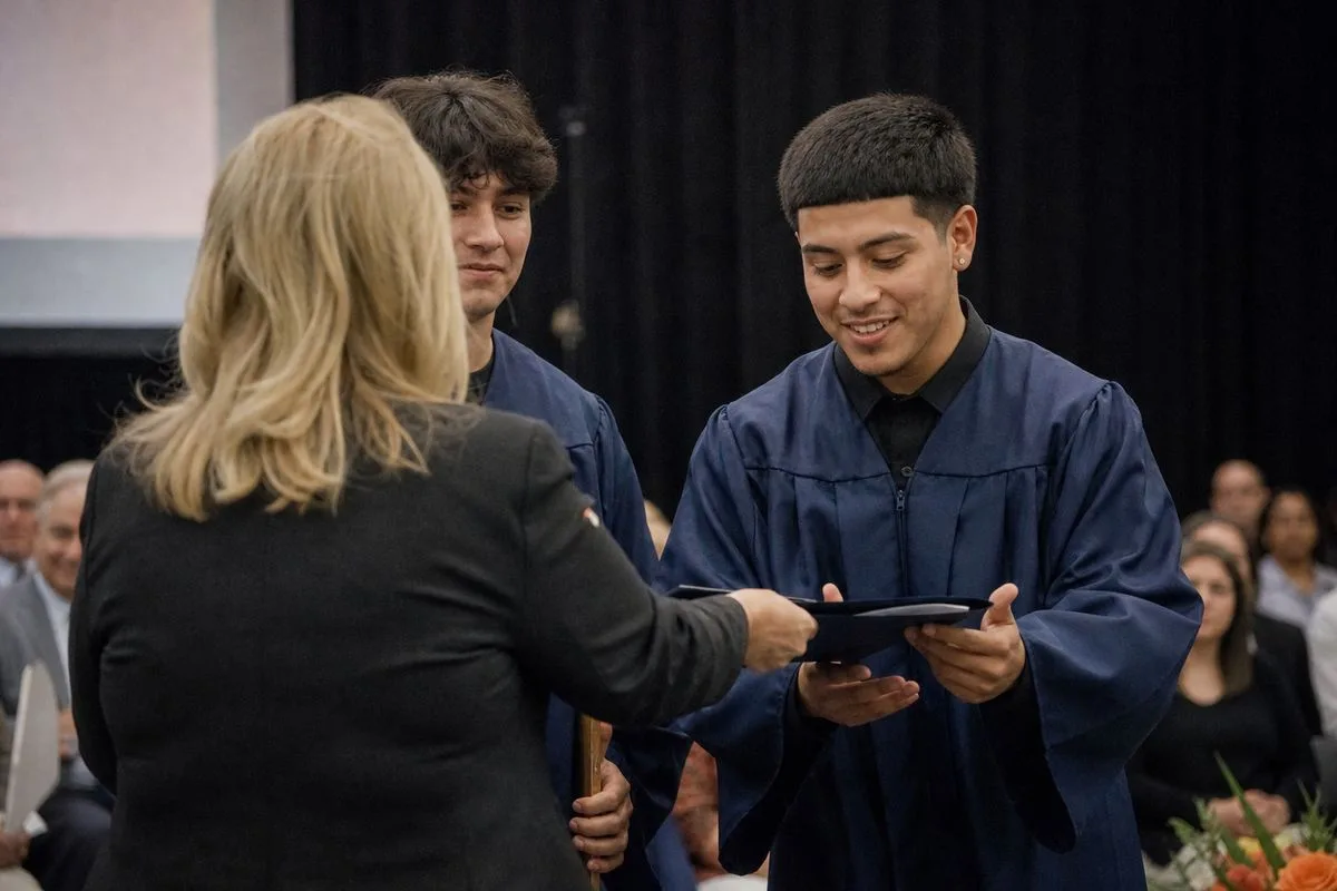 Students receiving certificates during a career tech graduation ceremony