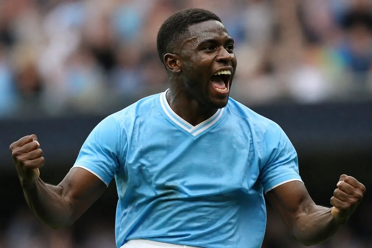 Micah Richards celebrating a goal in a Manchester City jersey