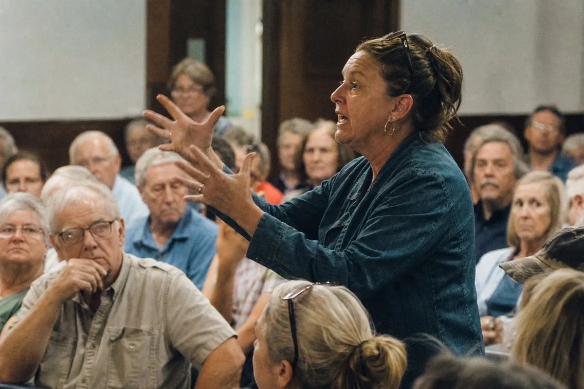 Residents speaking passionately at a town hall meeting