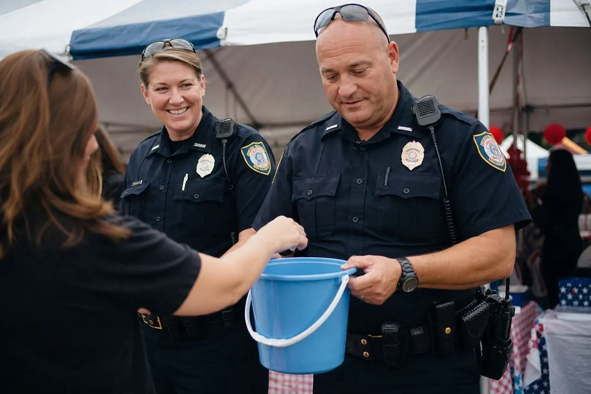 Police officers collecting donations at a community event