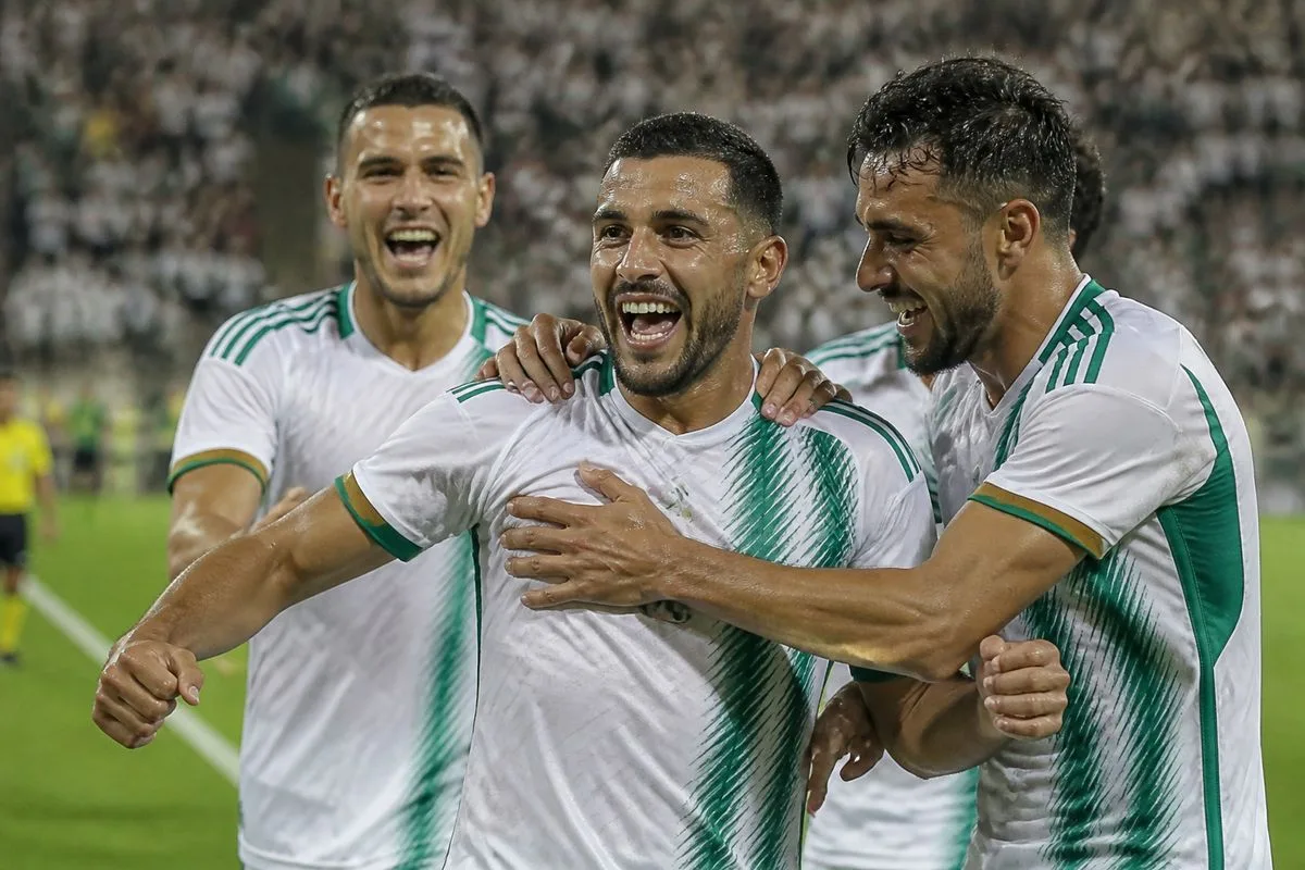 Algerian players celebrating a goal during a match.