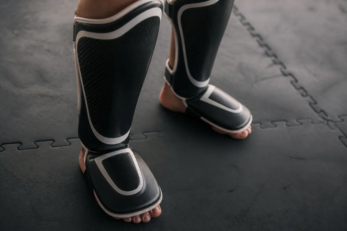 Close-up of Venum Kontact shin guards on a training mat
