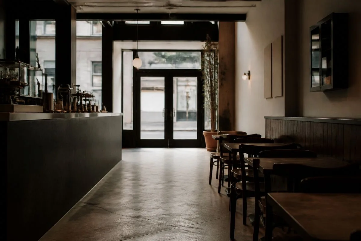 Empty coffee shop interior with closed sign on door