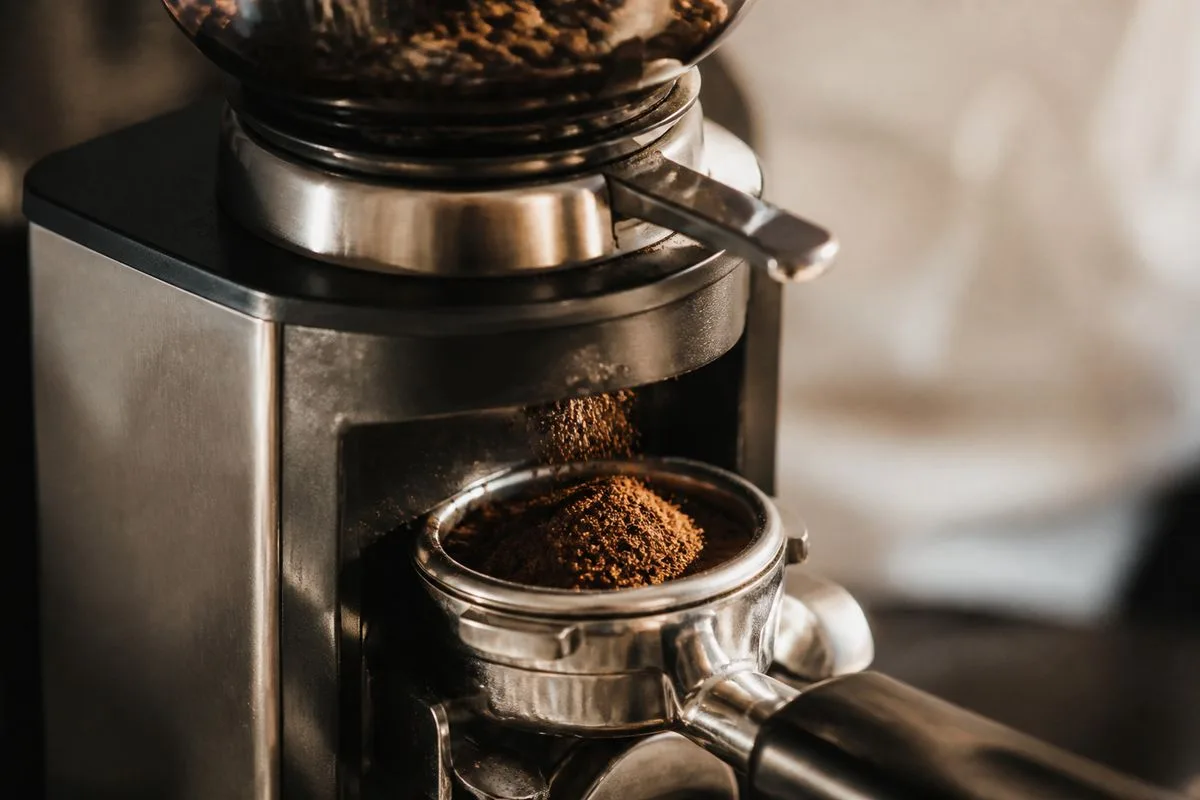 Close-up of a coffee machine grinding fresh beans before brewing