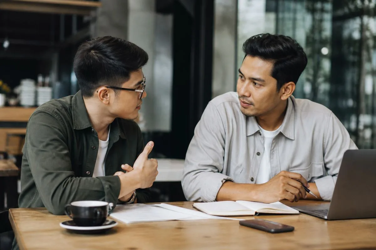 Two entrepreneurs discussing business plans in a cafe