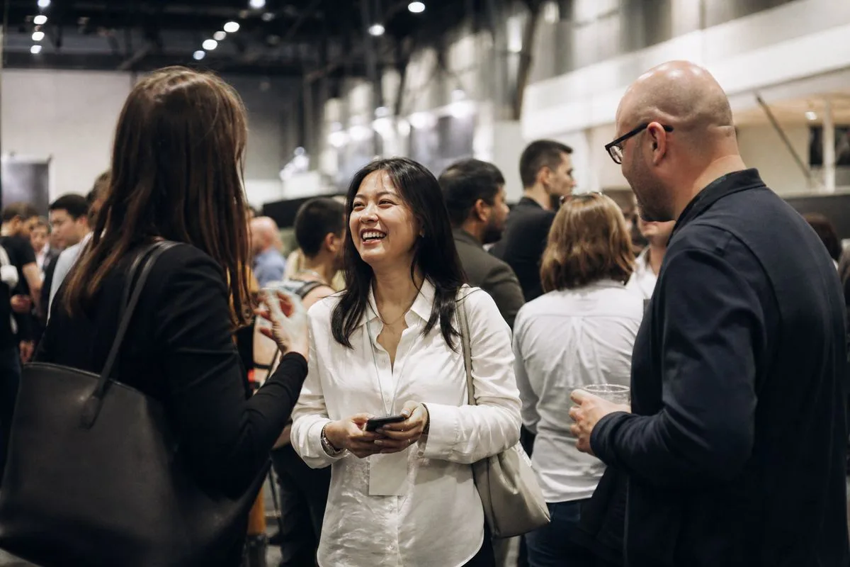 Attendees networking at a bustling e-commerce expo hall